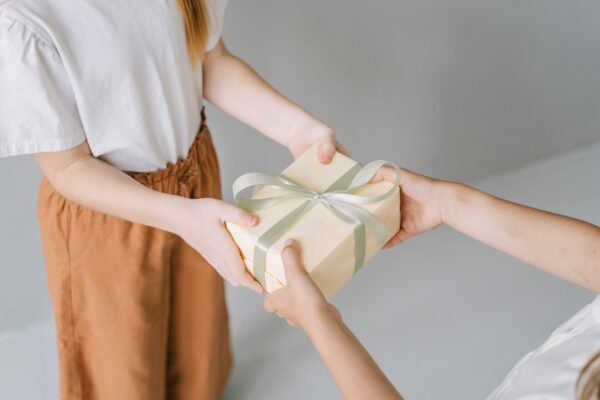 Displaying generosity by handing over a gift to someone else